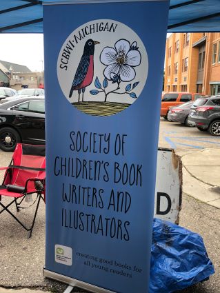 Sign for Society of Children's Book Writers and Illustrators for Michigan. Logo of a robin and a white flower