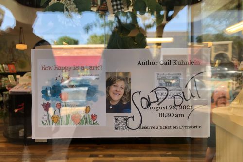 Sign on door about Gail Kuhnlein's reading at Coreander's with SOLD OUT written across it