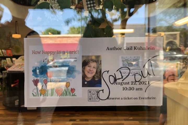 Sign on door about Gail Kuhnlein's reading at Coreander's with SOLD OUT written across it