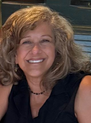 Headshot of Gail smiling, wearing a black sleeveless top