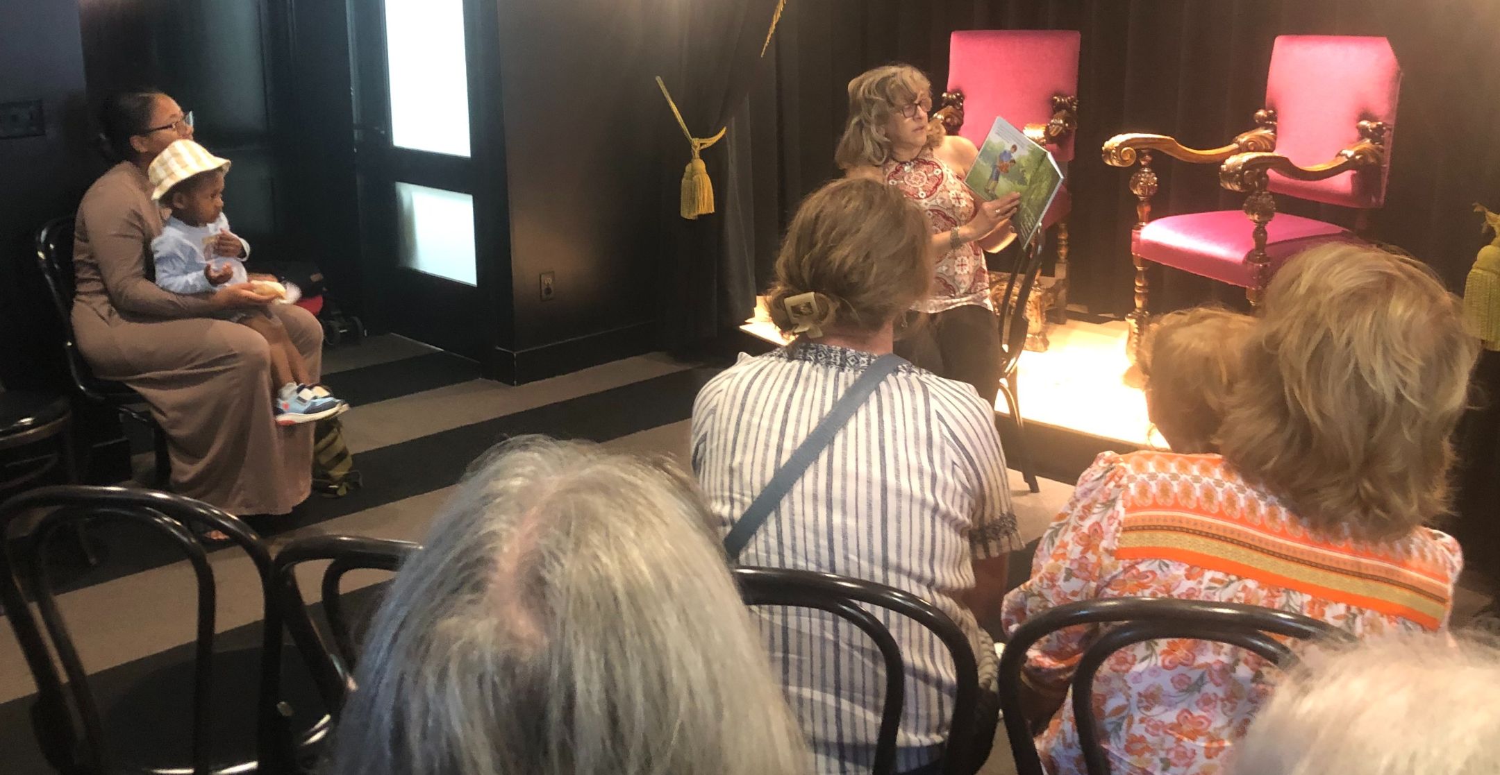 Gail reading in the Coreander's Children's Bookshoppe theater to a small audience