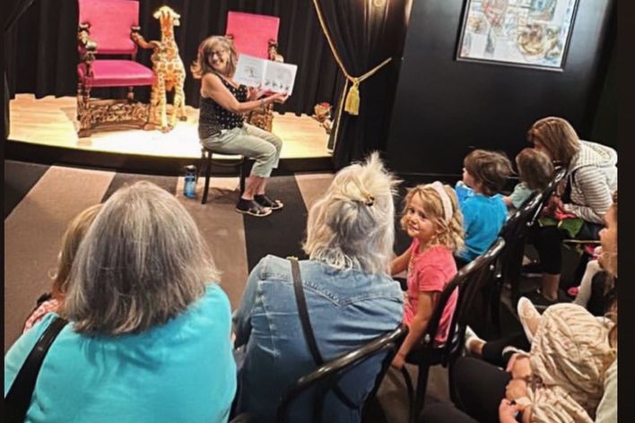 Gail reading to children and adults