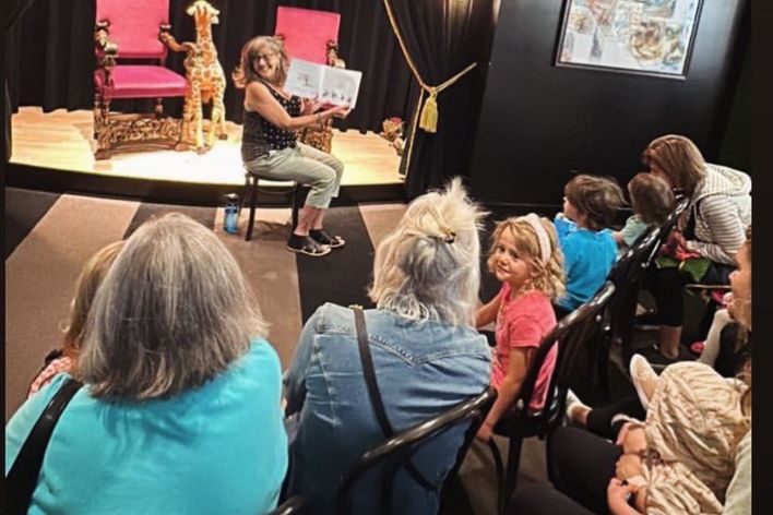 Gail reading to children and adults