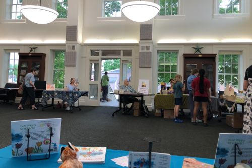 a view of the inside of the Chelsea Library from my author table, big open room, many windows