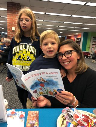 Mom reading to her son and daughter