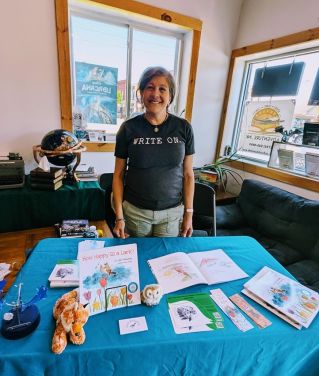 Gail standing at her author table
